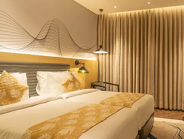 Deluxe room at Ramada Encore By Wyndham Bhiwadi featuring king bed and clean interior design