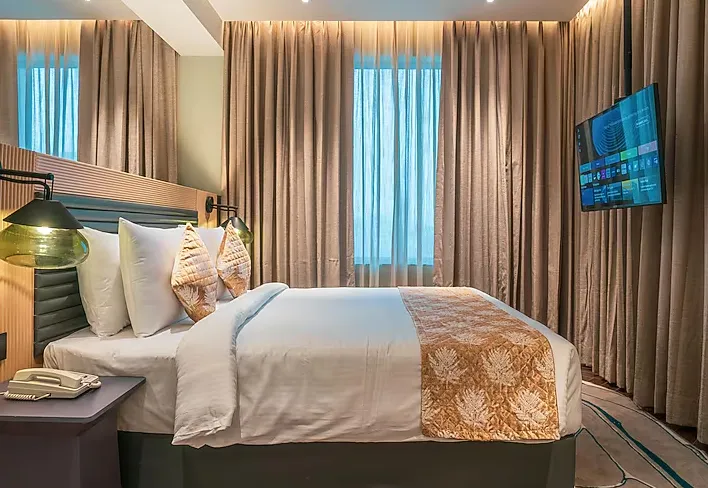 Deluxe room at Ramada Encore By Wyndham Bhiwadi featuring king bed and clean interior design