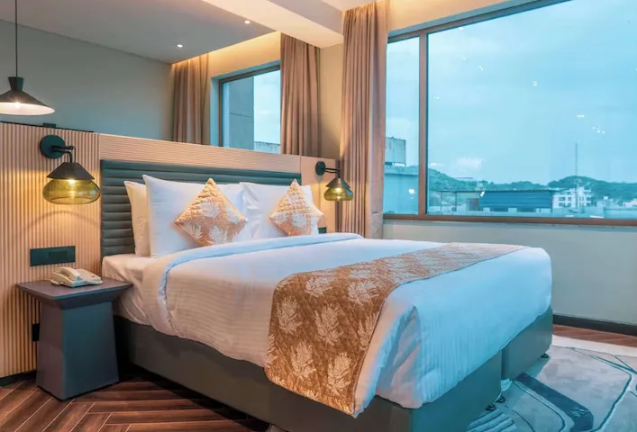 Deluxe room at Ramada Encore By Wyndham Bhiwadi featuring king bed and clean interior design