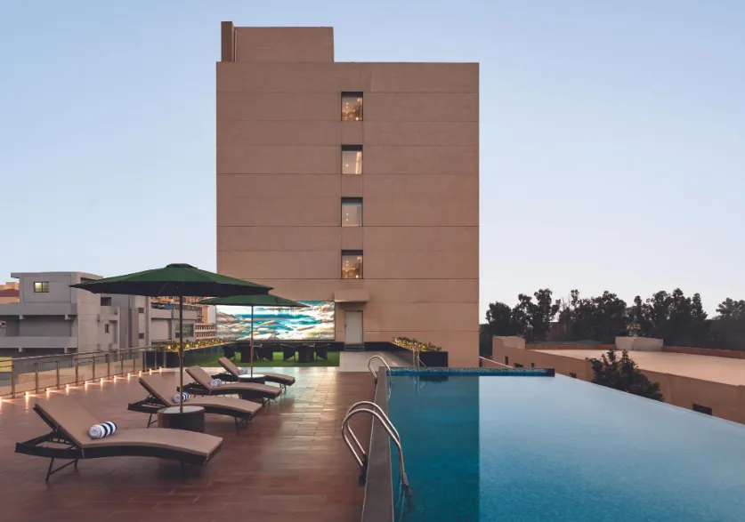 Dining area at Ramada Encore By Wyndham Bhiwadi with arranged tables and chairs