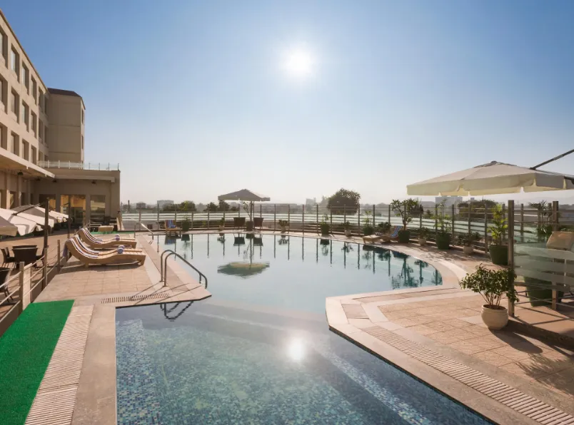 Restaurant at Ramada by Wyndham Neemrana with arranged dining tables and interior style