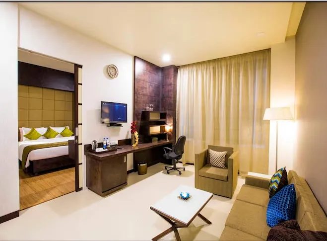 Suite at Regenta Central Grand Exotica Pune featuring separate living space and bedroom