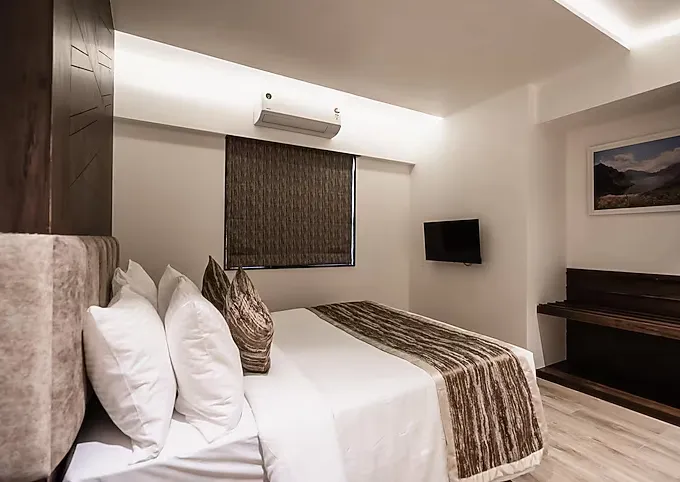 Executive suite living area at Regenta Place Igatpuri with sofa and coffee table