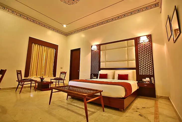 Executive room interior at Regenta Resort Vanya Mahal Ranthambore with bed and work space visible