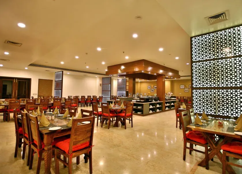 Restaurant at Regenta Resort Vanya Mahal Ranthambore showing dining tables and décor