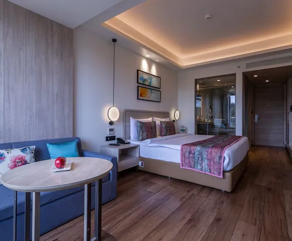 Delux room at Regenta SGS Greenotel Lonavala with bed and soft lighting