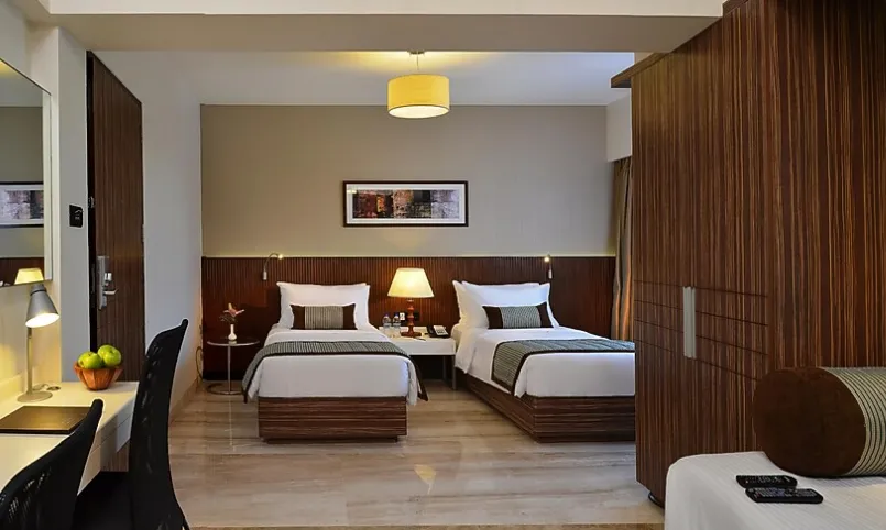 Deluxe room at Residency Sarovar Portico Goregaon Mumbai featuring modern decor and workspace