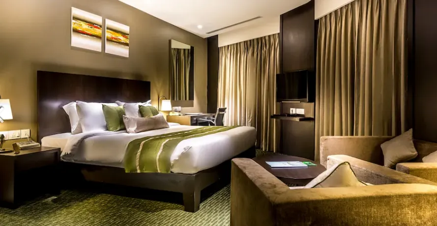 Deluxe room at Rodas An Ecotel Boutique Hotel Powai Mumbai featuring modern décor and seating area
