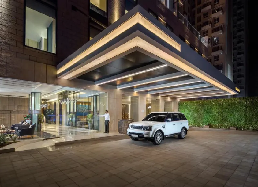 Hotel entrance of Royal Hometel Suites Dahisar with glass doors and name signage