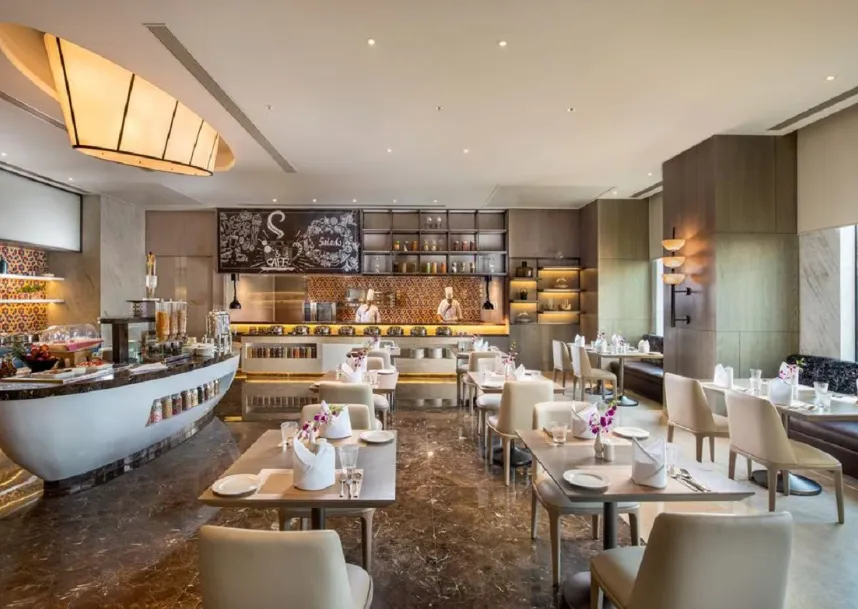 Restaurant at Royal Hometel Suites Dahisar with dining tables and warm lighting