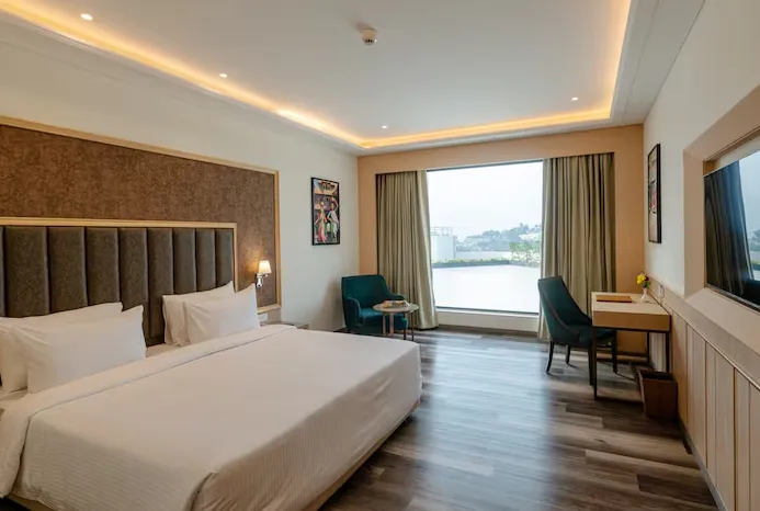 Superior room at Sarovar Portico Ajmer with bed and amenities