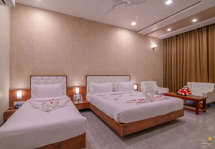 Executive style room at Savitri Resorts Pushkar with bed and work desk setup