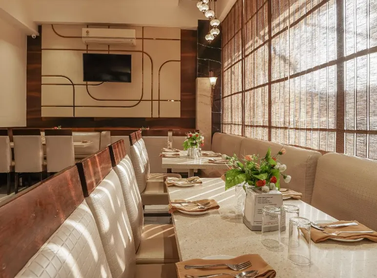 Restaurant at T2 Beacon Hotel Andheri with dining tables and chairs