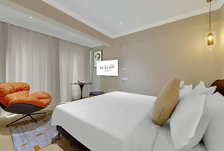 Modern room interior at The Beacon Hotel NIBM Pune with wooden flooring and wall art