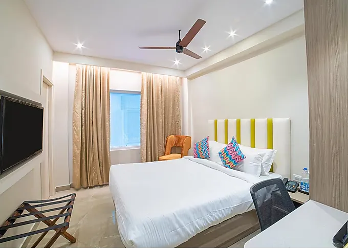 The Beacon Hotel Visakhapatnam deluxe room showing bed, desk, and decor