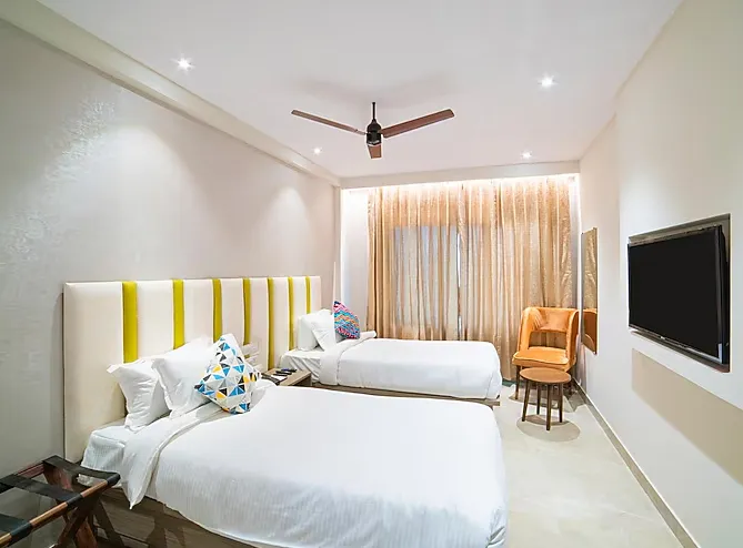 The Beacon Hotel Visakhapatnam executive room showing bed and desk