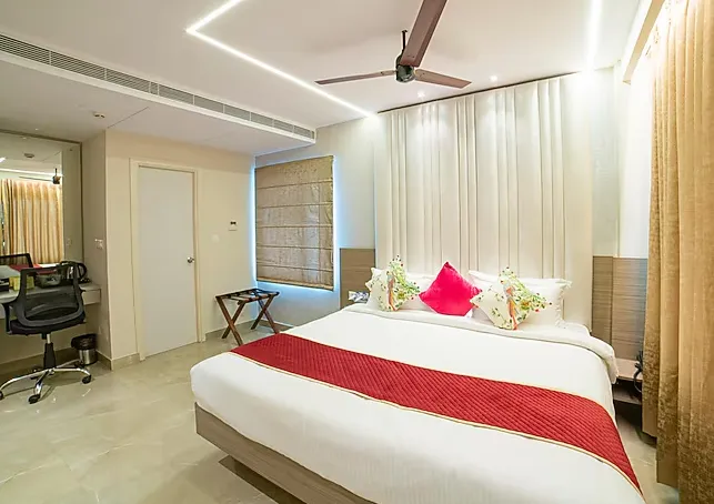 The Beacon Hotel Visakhapatnam suite room with living space and bed
