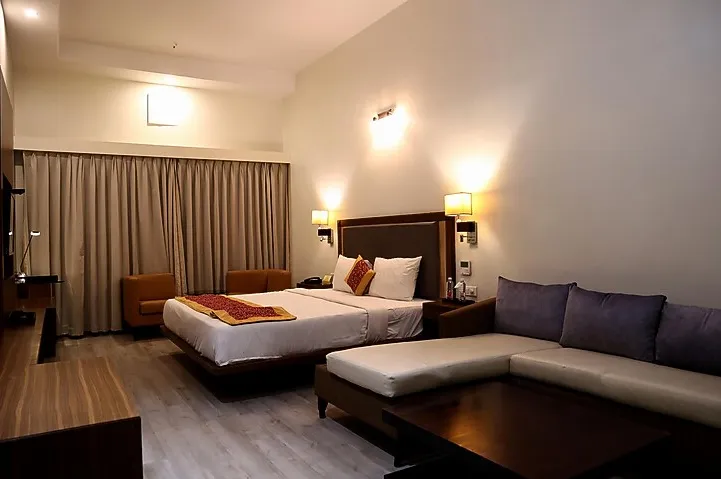 Fern Club Room at The Fern Residency Kakinada with bed and seating space