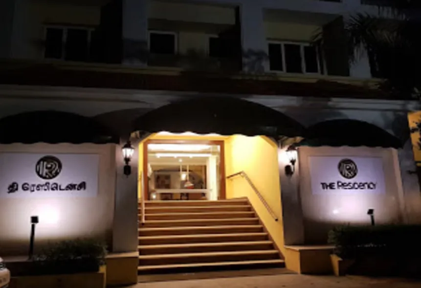 Front entrance of The Residency Karur with illuminated signage and driveway