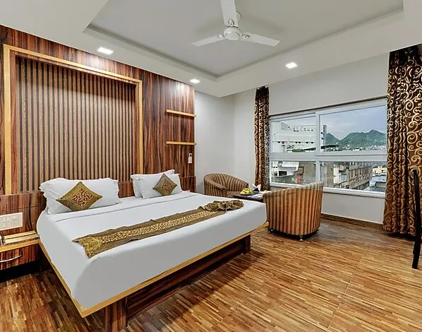 Deluxe room at The Royal Melange Beacon Ajmer featuring bed and modern décor