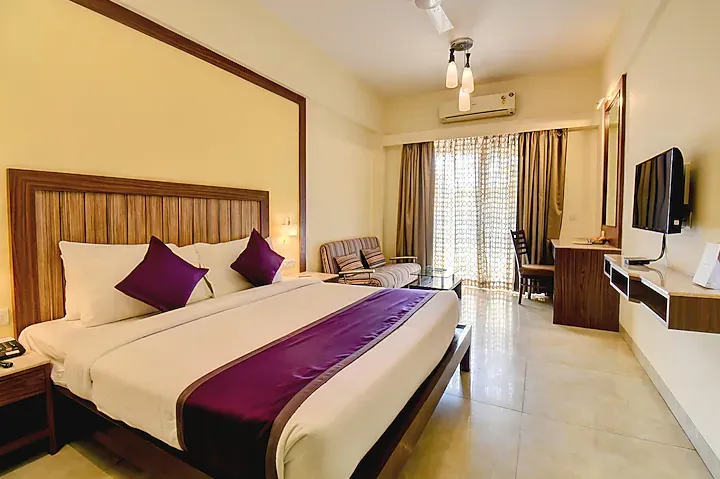 Executive room at VITS Lonavala with classic bed and work desk visible