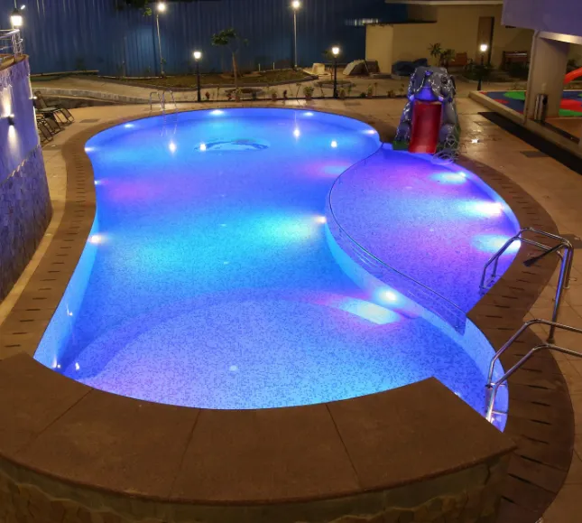 Outdoor swimming pool at VITS Lonavala with clear water and deck chairs