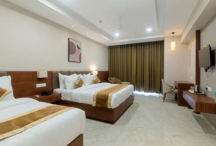 Deluxe room at VITS Satyajeet Karad featuring modern interiors and comfortable bedding