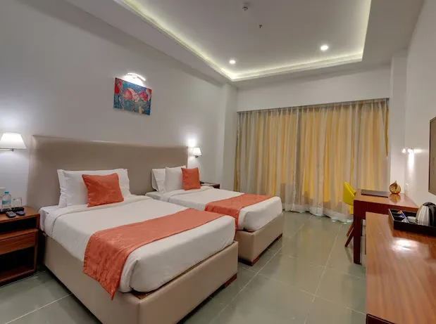 Deluxe room at Viola Beacon Resort Lonavala showing a large bed and neat interiors