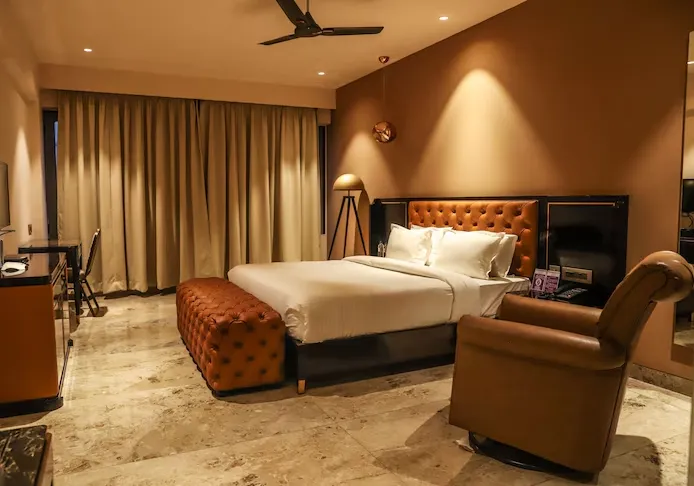 Deluxe room at Vits Hotels Nanded featuring modern furnishings and comfortable bedding