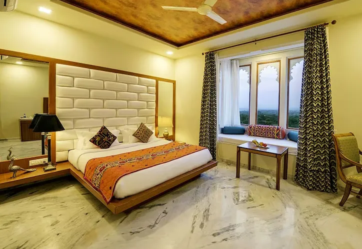 premium room at Brij Bhoomi Resort, Nathdwara with bed, soft linens, and calming décor