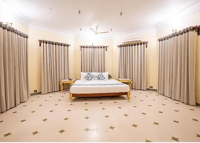 Junior suite at jüSTa Alwar Bagh Resort Sariska Alwar with separate seating and bed