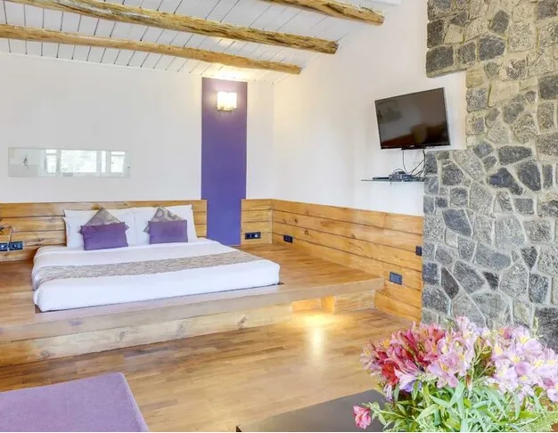 Superior room at Club Mahindra Resort Danish Villa Ooty with comfortable bed and bright window