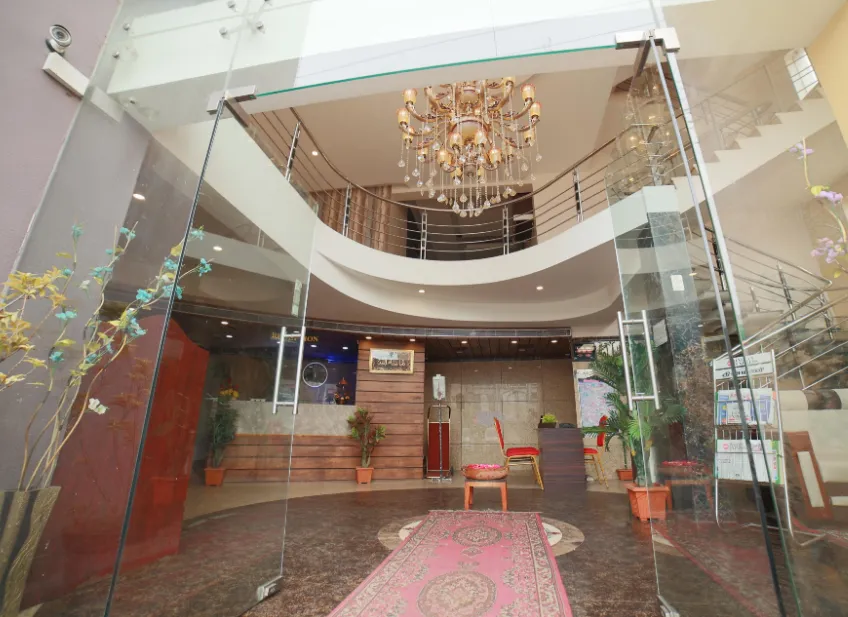 Front entrance view of Hotel President Madurai with signage and driveway access