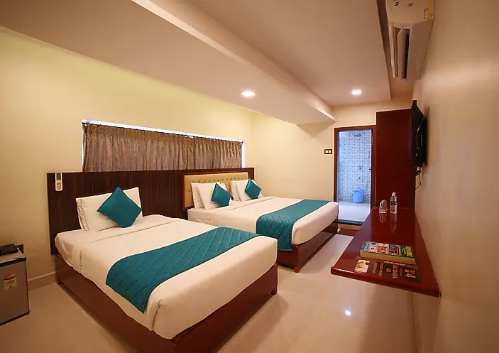 Executive room at Hotel President Madurai with desk setup and comfortable bedding