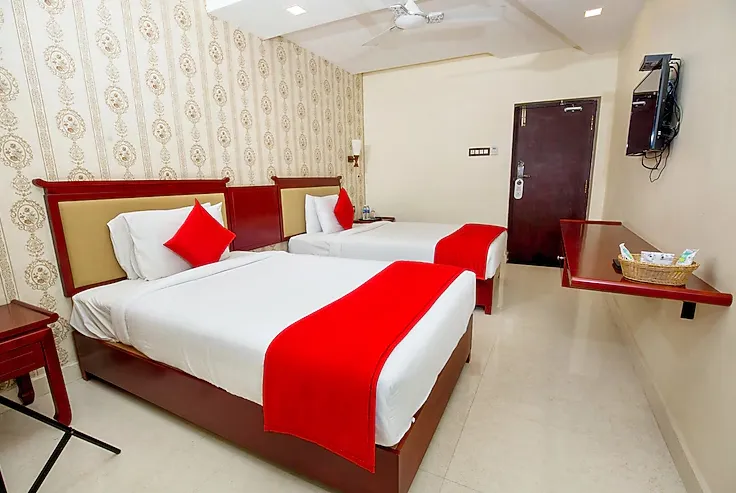 Executive room at Hotel President Madurai with desk setup and comfortable bedding