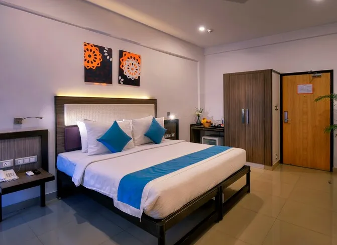 Deluxe room with double bed and work desk at TreeHouse Neptune Panaji Goa