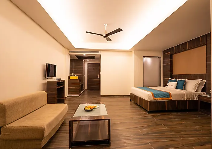Suite bedroom with king bed and lounge seating at Zone Connect by The Park Parra Goa